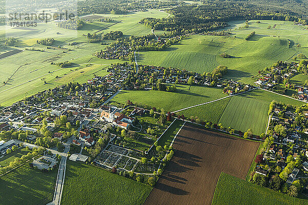 Germany  Bavaria  Berg  Aerial view of countryside village and surrounding fields and meadows in spring