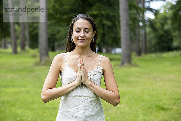 Smiling woman practicing yoga at Cannock Chase