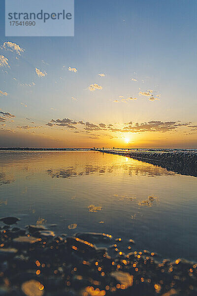 Beautiful Black Sea with clouds reflection at sunset