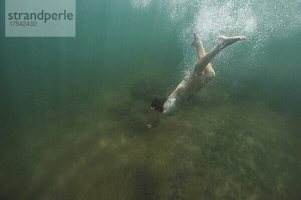 Woman swimming undersea on vacation
