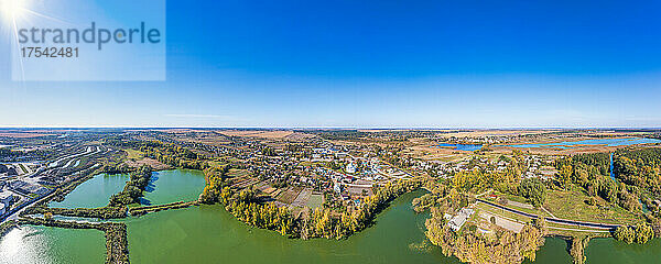 Ukraine  Zhytomyr Oblast  Chervone  Aerial panorama of lakeshore town on sunny autumn day