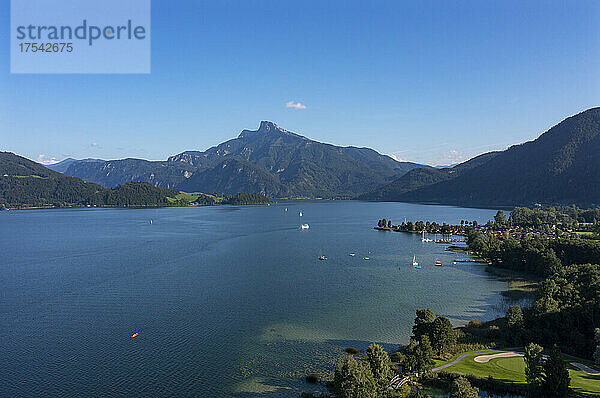 Drone view of Mondsee lake in summer with Schafberg mountain in background