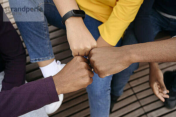 Multiracial friends doing fist bump