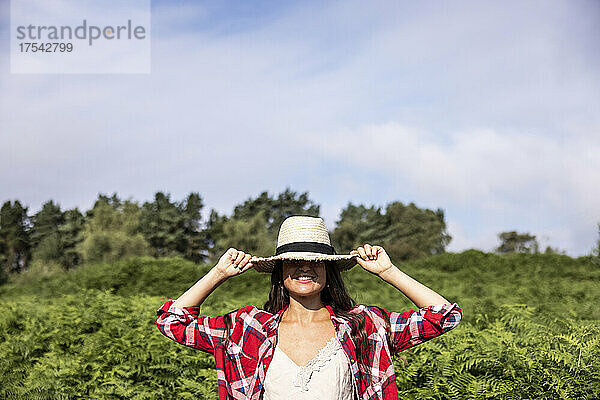 Smiling woman wearing hat at Cannock Chase on sunny day