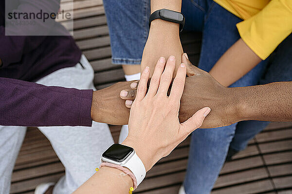 Multiracial friends doing hands stack