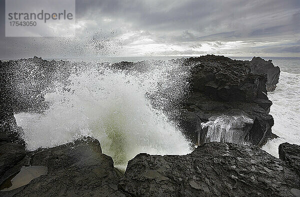 High tide waves splashing on rocks at Ponta da Ferraria  San Miguel  Azores  Portugal