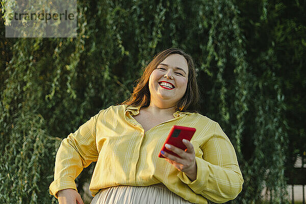 Happy woman holding smart phone
