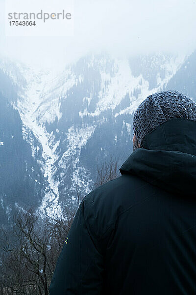 Türkei  Rückansicht eines Mannes mit Blick auf den mit Schnee und Nebel bedeckten Berg