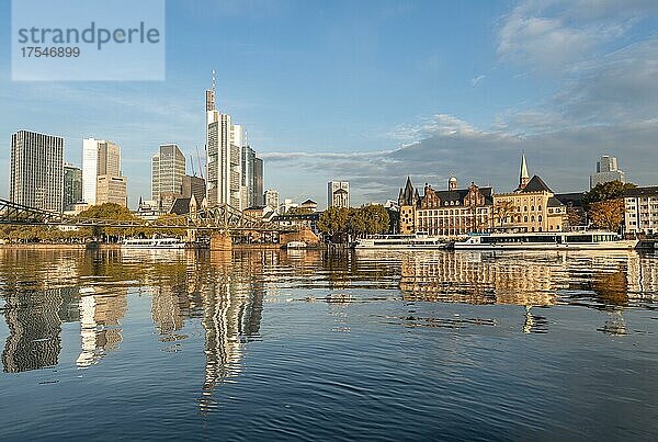 Ausflugsschiffe am Ufer  Blick über den Main  Skyline spiegelt sich im Fluss  Hochhäuser im Bankenviertel im Morgenlicht  Frankfurt am Main  Hessen  Deutschland  Europa