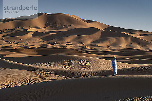 Ein Berber in traditioneller Kleidung in den Sanddünen von Erg Chebbi  Wüste Sahara  Marokko  Nordafrika  Afrika