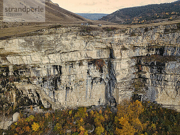 Aerial view of steep mountain cliff inÂ autumn