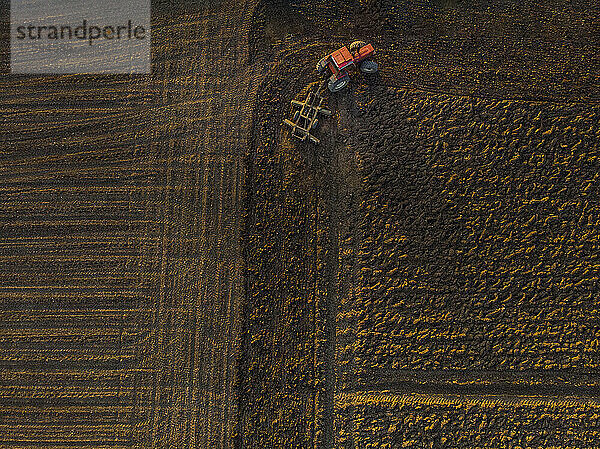 Drone view of tractor plowing field