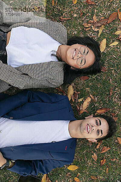 Multiracial business colleagues lying down on grass