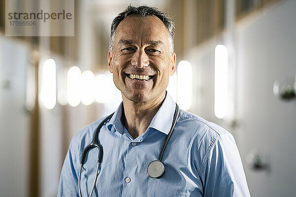 Cheerful mature doctor in hospital