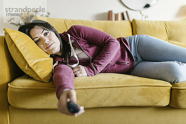 Young woman resting on sofa in living room