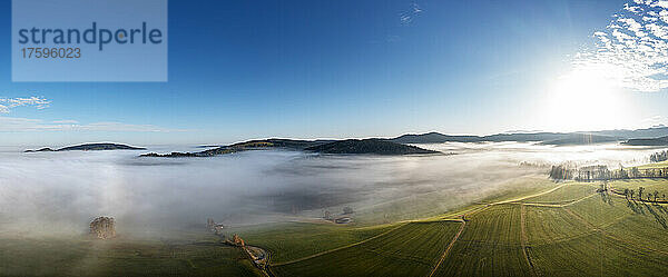 Drone panorama of agricultural fields at foggy sunrise