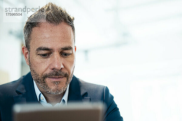 Businessman using tablet PC at workplace