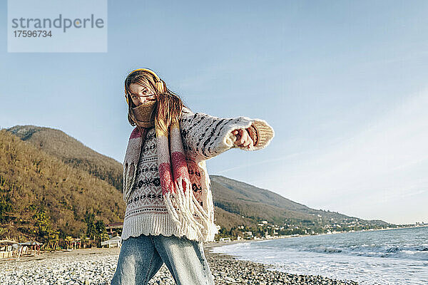 Girl in warm clothing enjoying vacation at beach  Gagra  Abkhazia