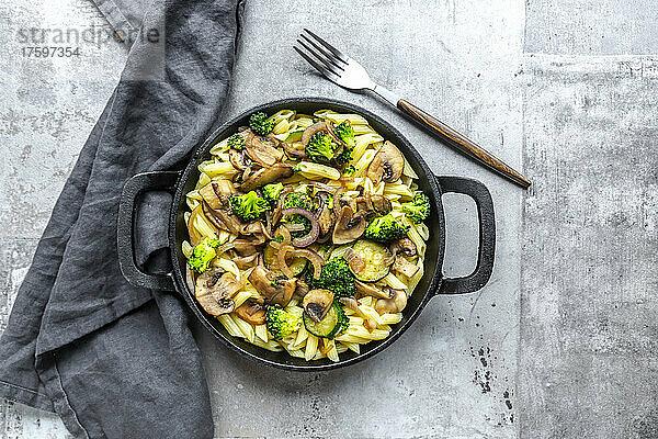 Penne pasta with mushrooms  broccoli  zucchini and onion