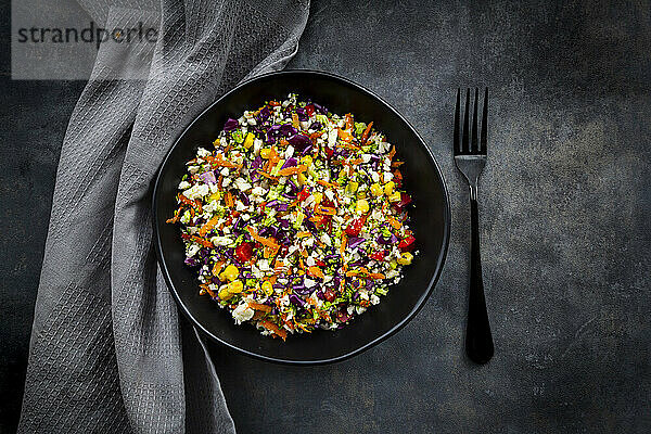 Studio shot of bowl of colorful vegan salad
