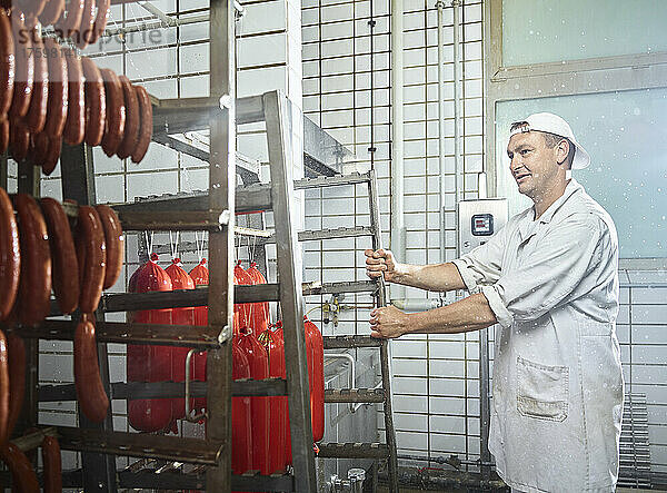 Butcher wearing apron working in food industry