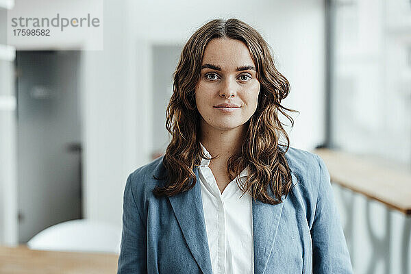 Beautiful smiling businesswoman with brown hair in office
