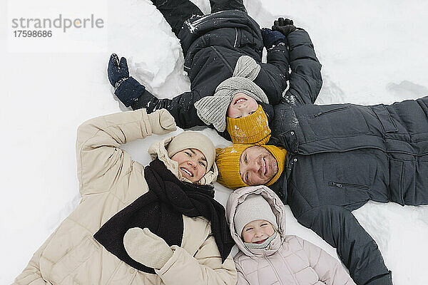 Happy family lying together on snow