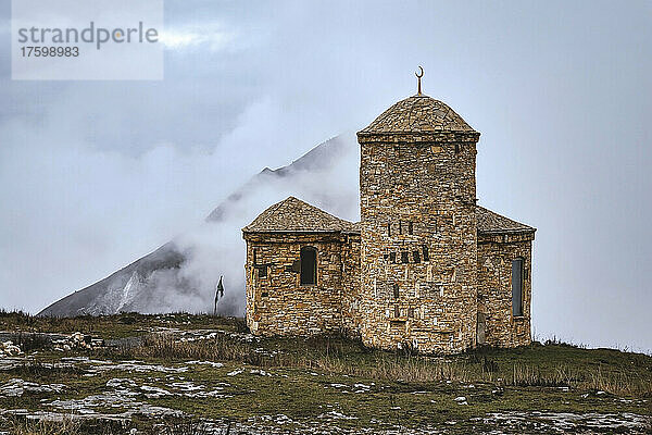 Russia  Dagestan  Old stone mosque in North Caucasus on foggy autumn day