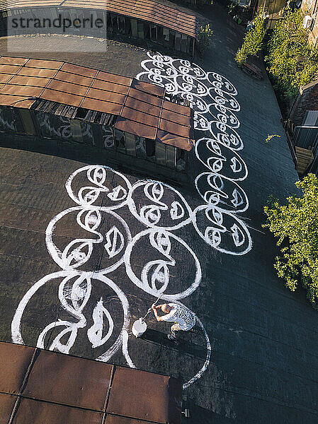 Artist painting graffiti on rooftop