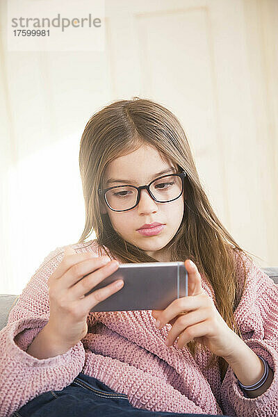 Girl looking at smart phone in living room