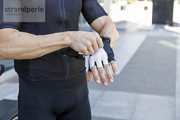 Young man wearing cycling glove