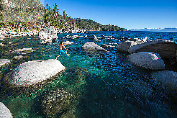 Ein Mann springt in der Nähe des Bonzai Rock in den Lake Tahoe.