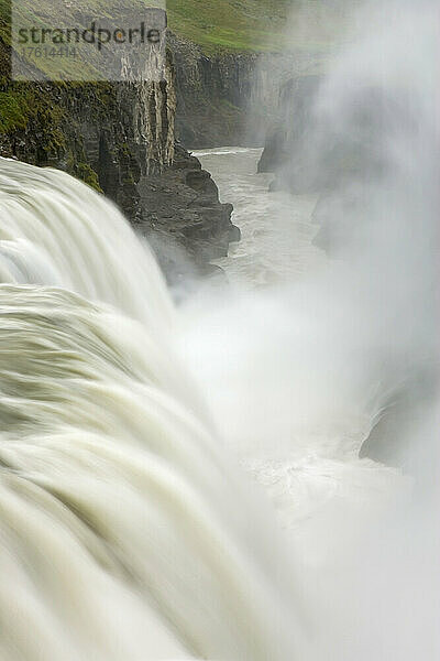 Am Gullfoss-Wasserfall  der von schmelzenden Gletschern gespeist wird  steigt Nebel auf.