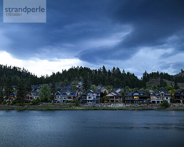 Wohnhäuser in einer Gemeinschaft um den Still Pond in der Dämmerung in Kelowna  BC  Kanada; Kelowna  British Columbia  Kanada
