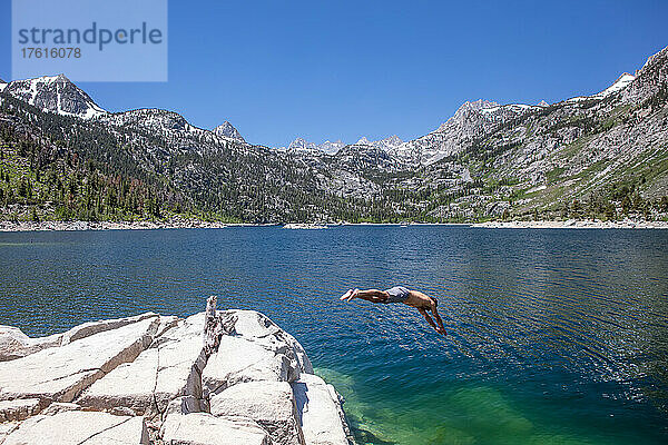 Ein Mann taucht in einen Bergsee in der Sierra Nevada.