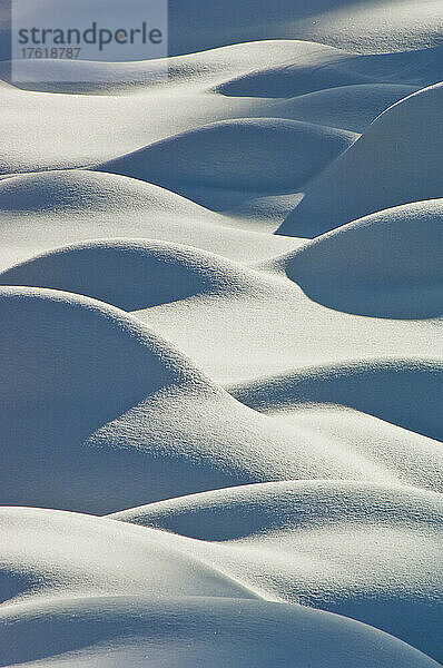 Abstraktes Muster von sonnenbeschienenen schneebedeckten Hügeln und Schatten; Yellowstone National Park  Vereinigte Staaten von Amerika