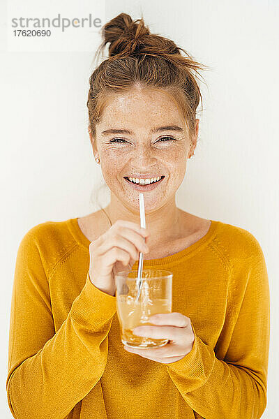 Happy woman with drinking glass against white background