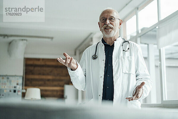 Senior doctor gesturing working at hospital