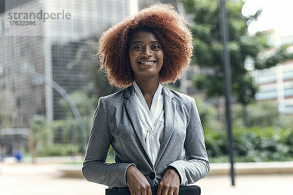 Portrait of young businesswoman smiling at camera