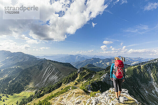 Female hiker admiring view from mountaintop