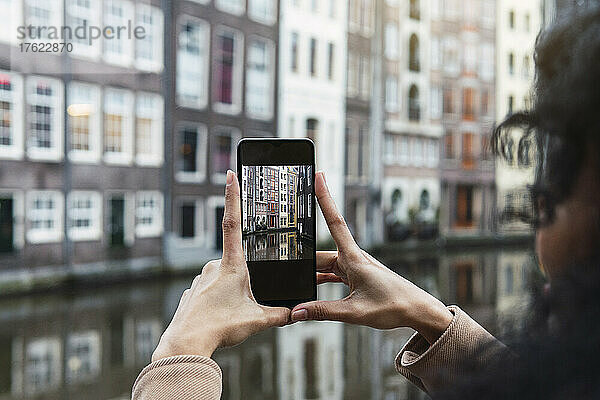 Junge Frau fotografiert Stadt per Smartphone