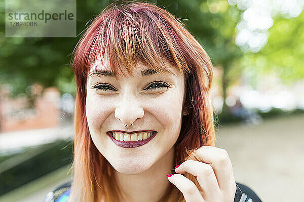 Cheerful redheaded woman with nose ring