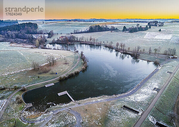 Aerial view of Aichstrut reservoir in winter at sunrise