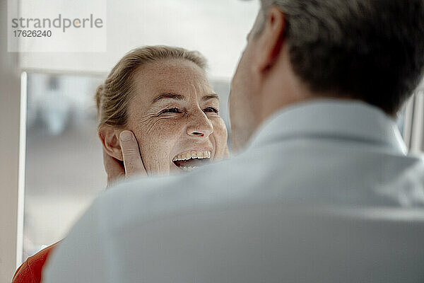 Businessman face to face with happy woman