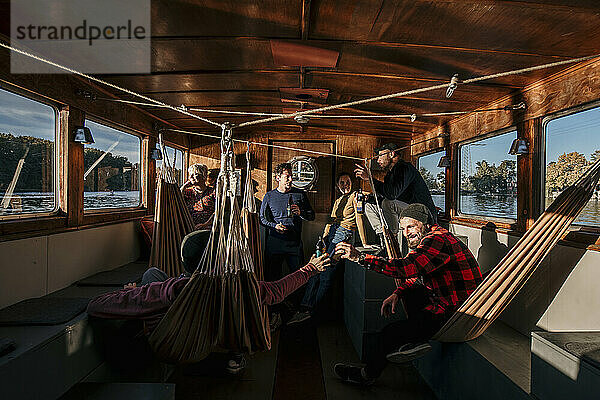Friends spending leisure time together on boat