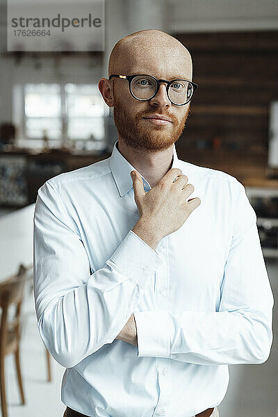 Young businessman wearing eyeglasses standing in office