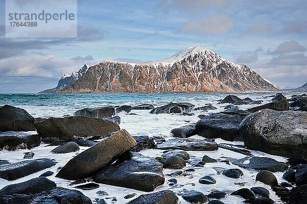 Rocky coast of fjord of Norwegian sea in winter. Skagsanden beach  Lofoten islands  Norway