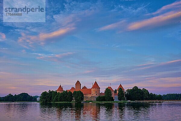 T Castle in lake Galve  Lithuania on sunset with dramatic sky reflecting in water. Castle is one of major tourist attractions of LituaniaTrakai Island
