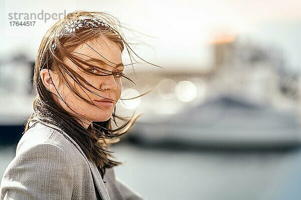 A portrait of an attractive young woman during windy weather