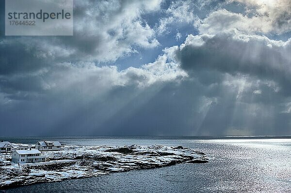 Norwegian sea in winter with sun rays through clouds. Lofoten islands  Norway
